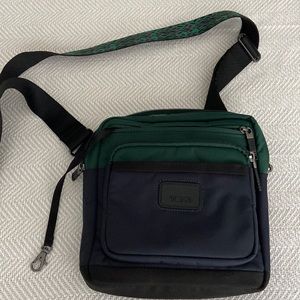 TUMI crossbody travel bag with multiple pockets